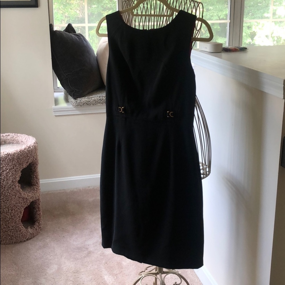 Figure flattering little black business dress.